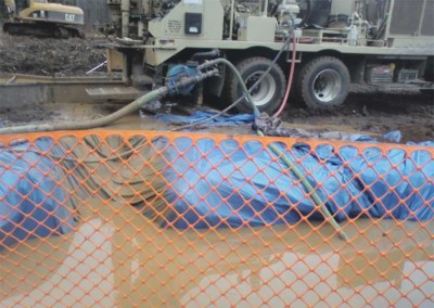Fluid containment system set up on site to prevent fluid spillage