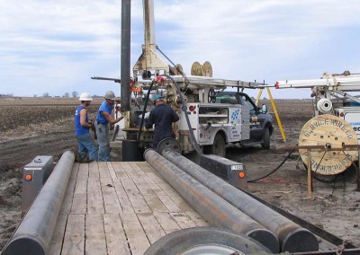 The pump crew is assembling the drop pipe and wire for a high capacity well